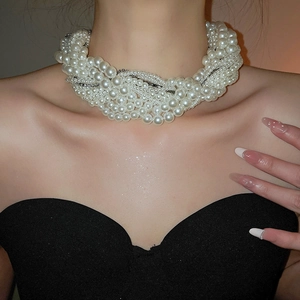 Close-up of a multi-layer knotted faux pearl choker with sparkling rhinestone accents