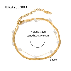 Detail of 18K gold stainless steel snake chain and white shell bead layering bracelet