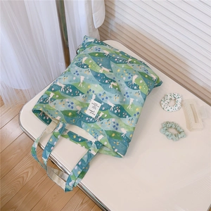 Detail of floral rabbit print cotton tote bag with matching green hair accessories