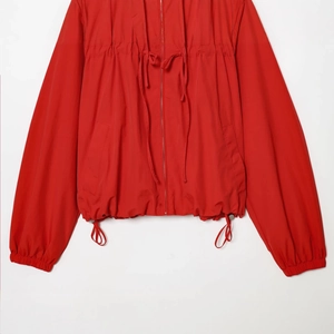French style red nylon hooded jacket with bow detail and adjustable drawstring waist