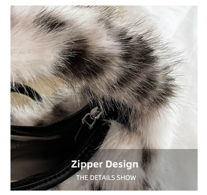 Detail view of the sleek black zipper closure on a plush leopard print crescent bag