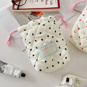Detail of quilted heart pattern drawstring pouch for cameras and accessories