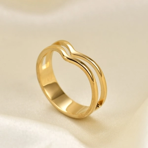 Minimalist double layer wavy stainless steel ring in gold finish on silk background