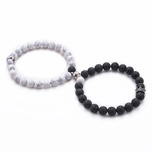 Detail of 8mm lava and howlite bead bracelets with crown charms and magnetic clasp