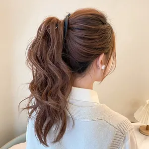 Rear view of a matte black banana clip securing a high ponytail on a female model