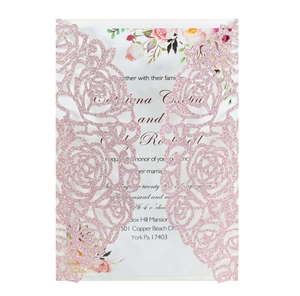 Detailed laser cut floral wedding invitation with pink glitter finish and printed insert