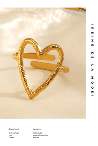 Macro view of adjustable 18K gold plated hammered metal heart ring on silk