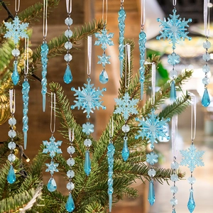 Close-up of clear acrylic Christmas ornaments including snowflakes and icicles on tree