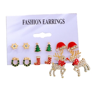 Close-up of 6 pairs of Christmas stud earrings featuring reindeer and snowflake designs