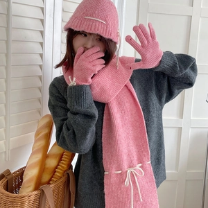 Pink knitted winter set featuring a cozy beanie, scarf, and gloves for cold weather