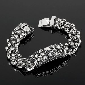 Macro detail of men's vintage rock skull bracelet with polished silver steel chain links