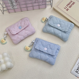 Quilted mini wallets with snap buttons and bear cookie keychains in soft pastel colors