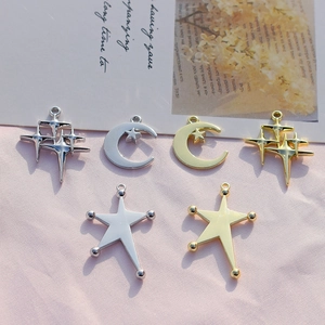 Detail shot of celestial charms featuring gold and silver alloy stars and moons on silk
