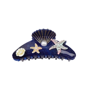 Sparkly dark blue ocean hair claw clip with seashells, starfish and pearls on white background