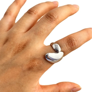 Minimalist silver irregular organic ring with high-polish liquid metal texture on hand