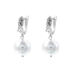 Close-up of elegant silver earrings with shimmering cubic zirconia and round pearls