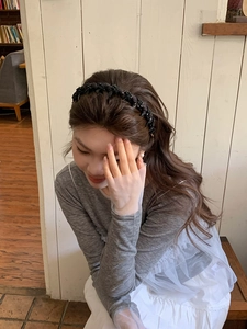Close-up of model wearing black beaded mesh headband for stylish hair styling