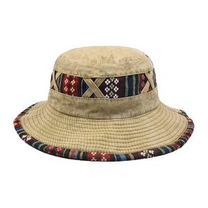 Close-up of khaki bucket hat featuring colorful ethnic geometric embroidery on the brim