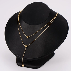 Elegant gold double-layered ball pendant necklace displayed on a black jewelry bust