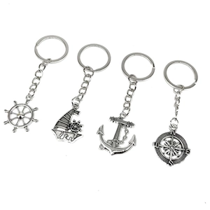 Retro nautical keychain set with silver anchor, compass, rudder and sailing boat charms