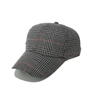 Detailed view of houndstooth baseball cap with red stripes and thick textured fabric