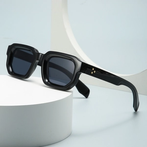 Modern rectangular sunglasses with black frame and golden star rivets on light blue background