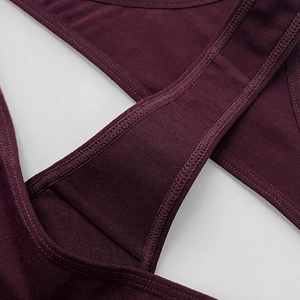 Detailed close-up of dark purple ribbed cotton thong with reinforced stitching for fitness