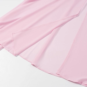 Detail view of pink chiffon skirt hem showing fine stitching and side slit craftsmanship