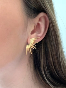 Close-up of 18K gold-plated sunburst stud earrings with geometric spike design