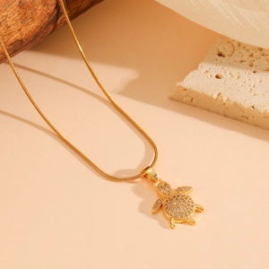 Golden titanium steel necklace featuring a cute sea turtle pendant with sparkling crystals