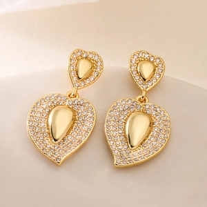Luxury 18K gold plated heart earrings with zircon inlay on soft beige fabric background