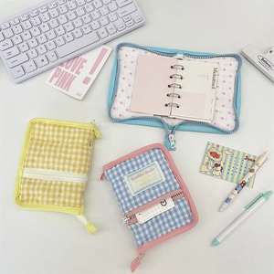 Close-up of quilted fabric mini binder with heart stitching and metal rings