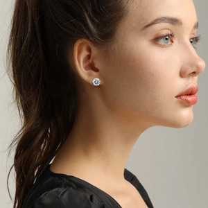 Detailed view of model wearing a classic silver stud earring with a brilliant round cut zircon