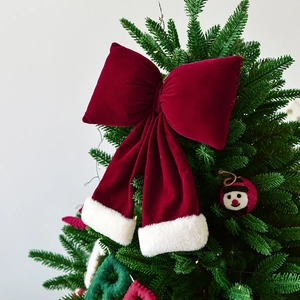 Red velvet Christmas bow with white faux fur trim as festive holiday tree topper decoration