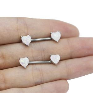 Detail showing high-quality heart-shaped white opal nipple ring with silver steel bar