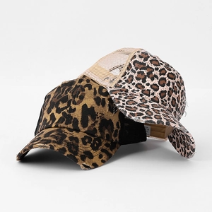 Detail of distressed leopard print baseball caps with mesh back and frayed brim texture