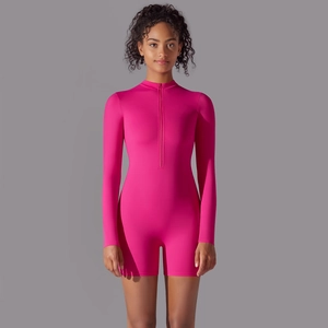 Detail of hot pink athletic bodysuit with half-zipper neckline and long sleeves