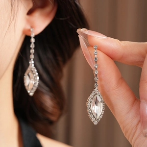 Detail of luxury teardrop tassel earrings with sparkling crystals and silver finish