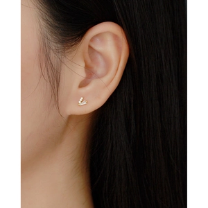 Close-up of model wearing gold V-shaped S925 silver stud earring with clear crystals