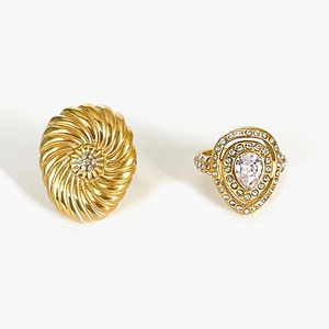 Golden double ring set with large spiral flower and pear-shaped diamond accents