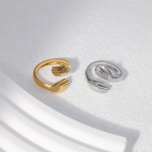 Detail of adjustable open hug hand rings in gold and silver stainless steel finish