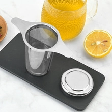 Macro shot of 304 stainless steel tea infuser with lid on a minimalist black tray