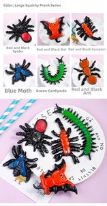 Macro shot of large TPR squeezy toy insects including spiders and scorpions set in a tray