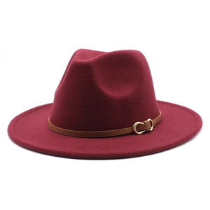 Detail van een wijnrode wollen fedora met bruine leren riem en gouden gesp