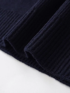 Macro shot of navy blue rib-knit fabric texture on the collar for long sleeve sweater