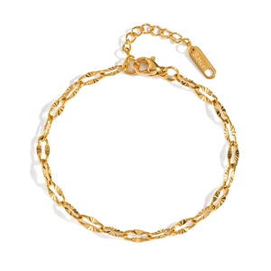 Detailed macro view of a gold stainless steel chain bracelet with lobster clasp