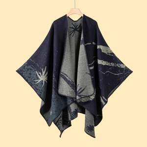 Detail of grey and navy knit shawl with ginkgo leaf patterns and fringe edges