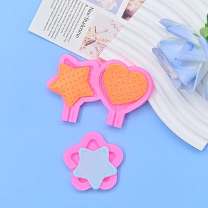 Close-up of pink silicone mold with star and heart shapes for DIY craft resin accessories
