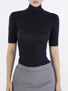 Detail of a slim-fit black high-neck T-shirt showing soft tencel lycra fabric texture