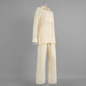 Detailed close-up of light yellow long sleeve shirt and wide-leg trousers texture
